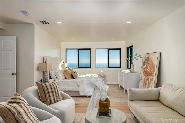 Ocean view primary Bedroom with seating area
