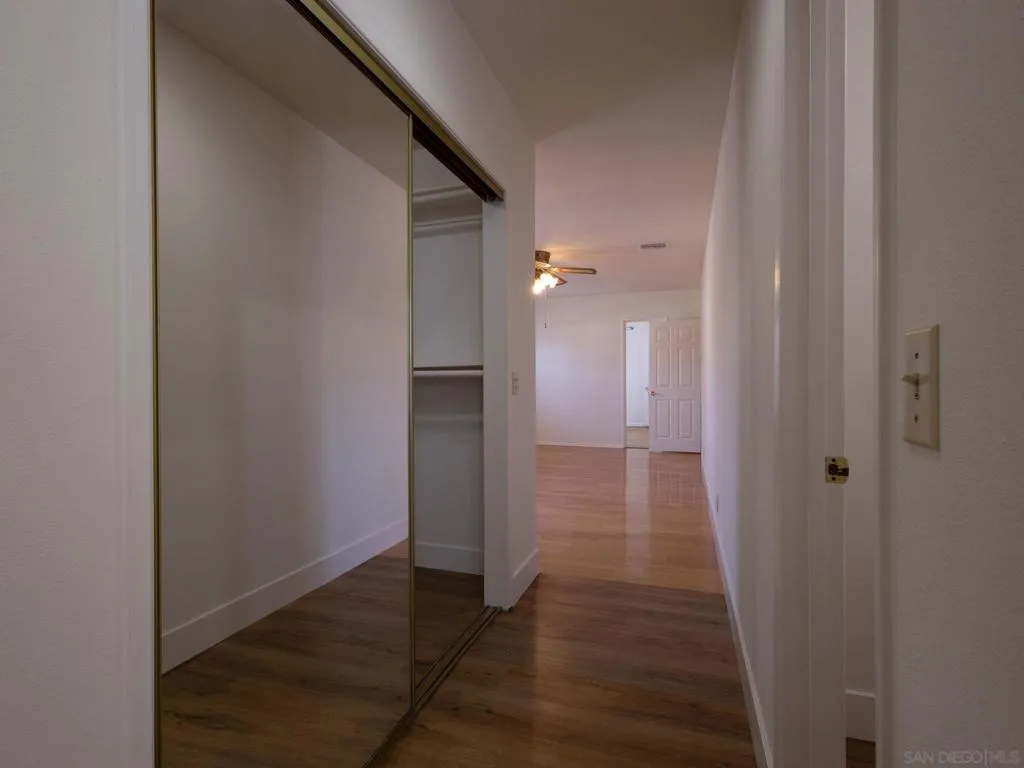 Hallway in the Master Bedroom.  Shows Walk In Closet to the left and entry to the room with the toilette and bidet.  in the far side of the photo you can see the entry to Bedroom 4 if a master suite or ADU is desired