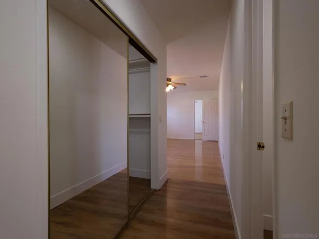 Hallway in the Master Bedroom.  Shows Walk In Closet to the left and entry to the room with the toilette and bidet.  in the far side of the photo you can see the entry to Bedroom 4 if a master suite or ADU is desired