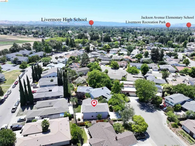 Aerial perspective of a residential neighborhood with numerous trees and established properties