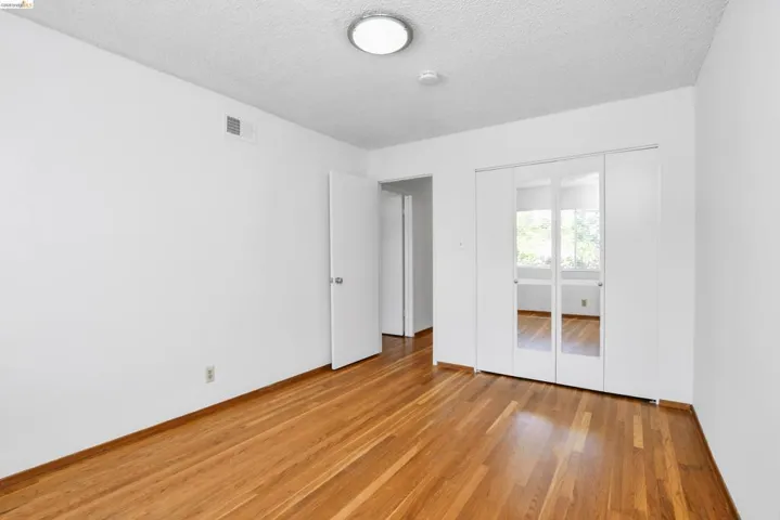 Hardwood flooring throughout, featuring a bright white color palette
