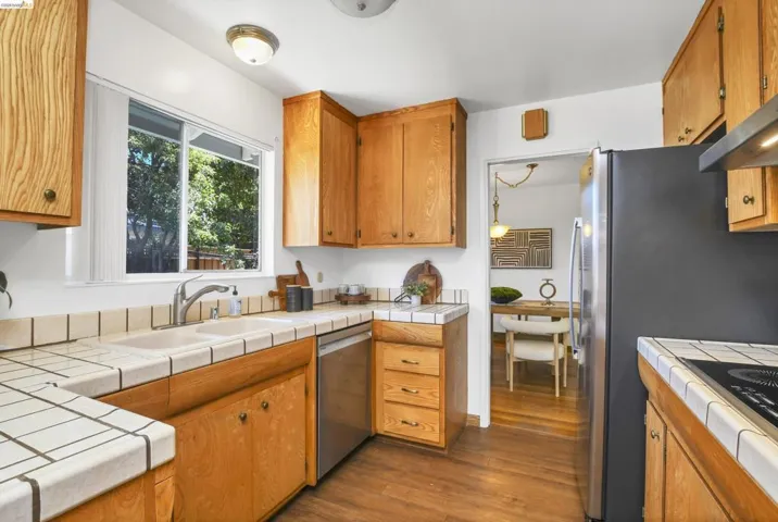 Kitchen featuring wood-finish cabinetry and tile countertops
