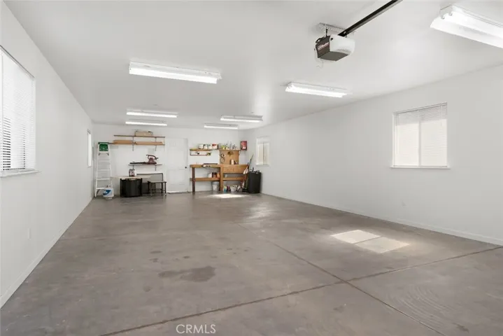 Shelving, door to flex space. Plans for creating this into more!