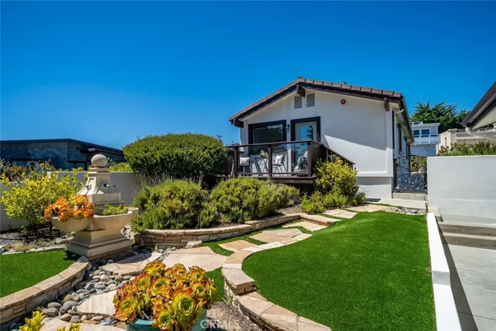 Elegant landscaping, turf, stone steps and fountain