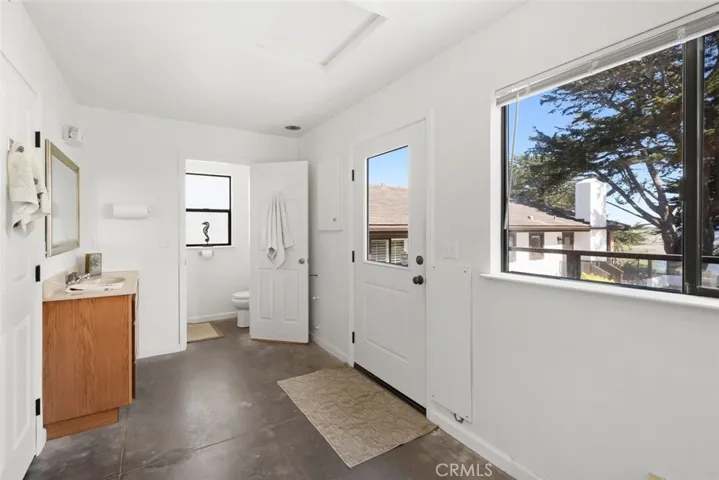 Flex space in front of garage with ocean views and half bath.