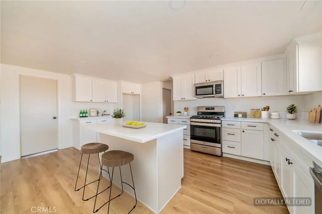Remodeled Kitchen with new appliances. (Disclaimer: Some images have been digitally enhanced with virtual staging to illustrate potential room layouts and furnishings. Actual property condition and features may vary. Buyer to verify all information independently).