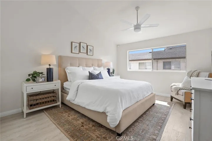 Primary bedroom also has high ceilings, ceiling fan & light.  The large window lets in lots of natural light.