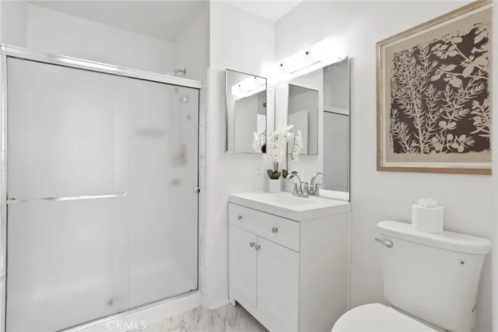 Primary bathroom en-suite has new cabinet, flooring, mirror and toilet.