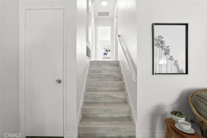 Storage closet and stairs that lead to the bedrooms and bathrooms.