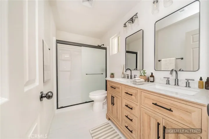Remodeled Primary Bathroom (Disclaimer: Some images have been digitally enhanced with virtual staging to illustrate potential room layouts and furnishings. Actual property condition and features may vary. Buyer to verify all information independently).