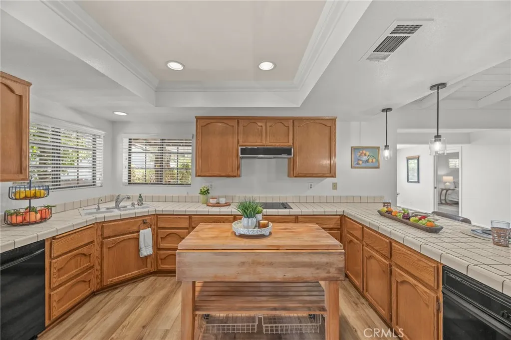 Kitchen view w/portable island, recessed lighting