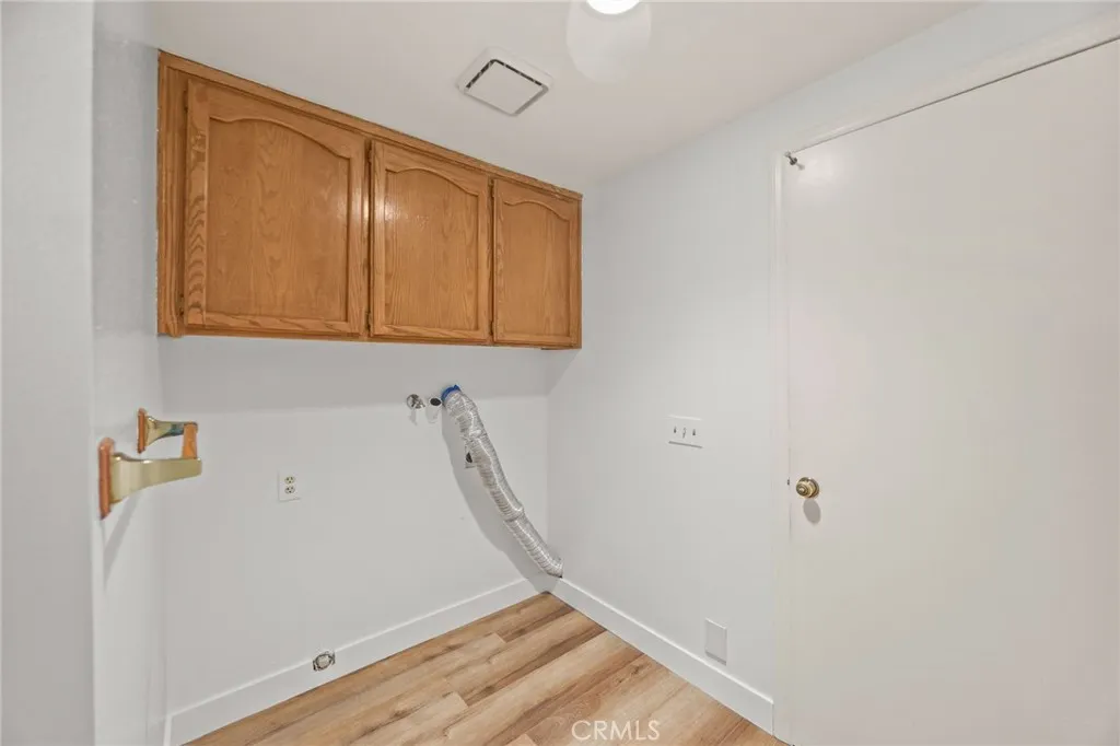 Laundry area w/storage and door to garage