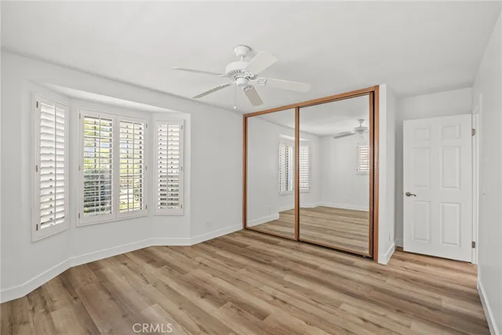 2nd bedroom facing front yard w/mirrored sliding closet doors & ceiling fan