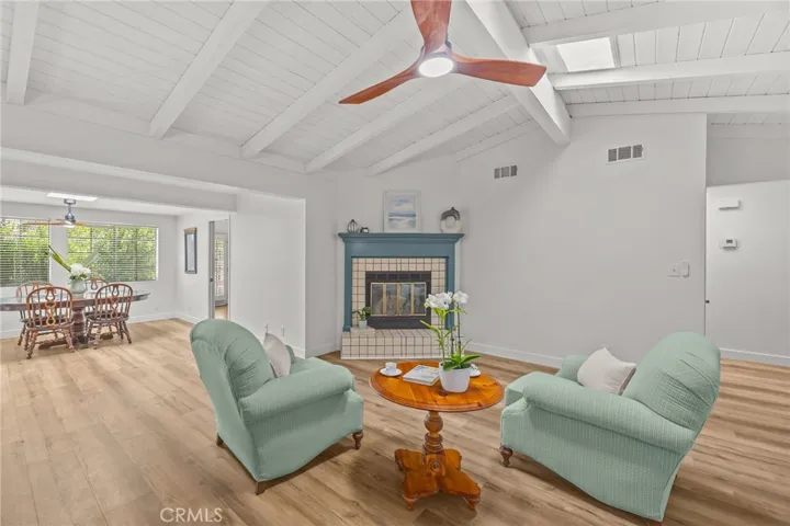 Living area w/fireplace, vaulted ceiling, skylight and fan