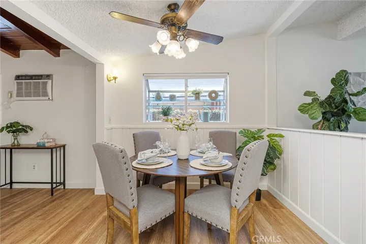 Dining area off from kitchen with a garden window and ceiling fan. Newly painted and installed vinyl plank flooring. Wall AC in family room with beamed ceilings. Newly painted and newly installed vinyl plank flooring.