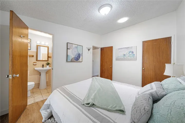 Primary bedroom with private bathroom located at the end of the hallway. The primary has a solar light tube that allows natural light to pour through. Newly painted and newly installed vinyl plank flooring.