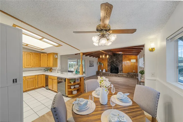 Dining area opens up to the kitchen and family room with fireplace. Sliders to covered patio. Newly painted and newly installed vinyl plank flooring.