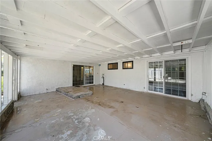 Slider at right leads to the primary bedroom. The other sliders lead to the family room. Washer and dryer hookups at patio.