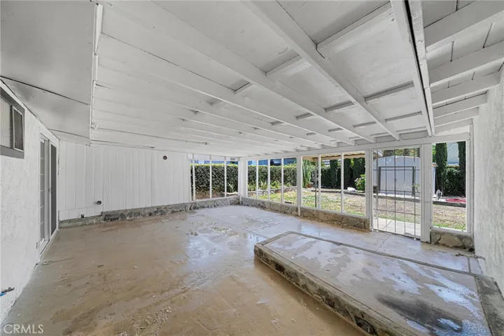 The raised portion at the patio used to be a planter. Long ago it was filled with concrete where they had work out gear placed. Washer and dryer hookups at patio.