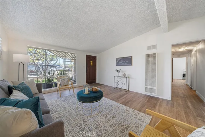 Roomy living room with large picture window. Newly painted and newly installed vinyl plank flooring. Hallway to bedrooms and bathrooms.