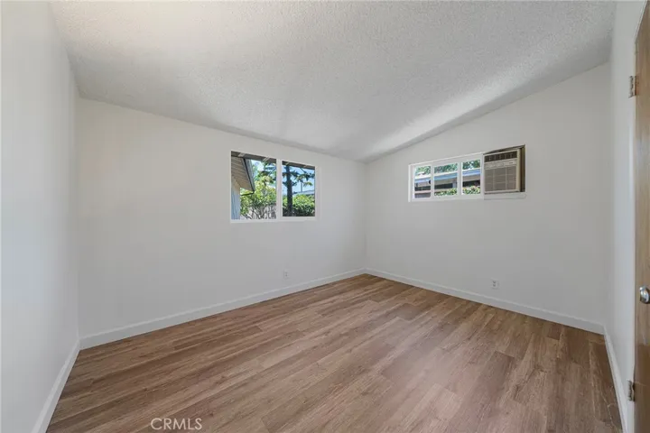 One of three bedrooms with window AC. This is facing the front corner. Newly painted and newly installed vinyl plank flooring.