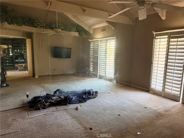 Primary bedroom featuring a mirrored wall.