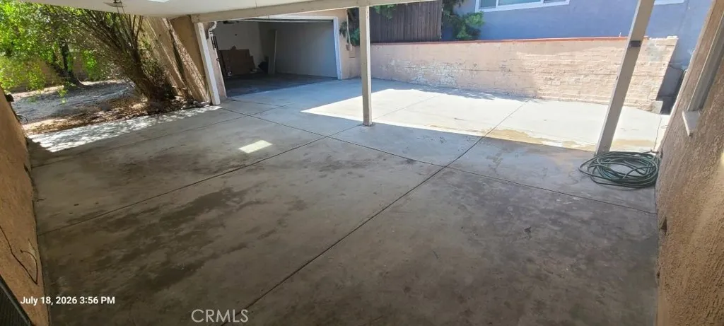 Large covered patio, looking to Garage.