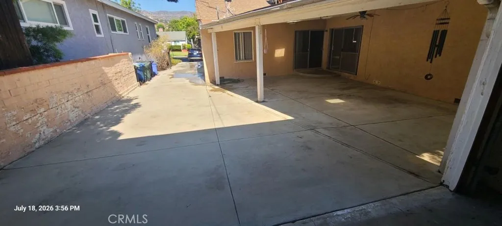 Rear driveway, covered patio.