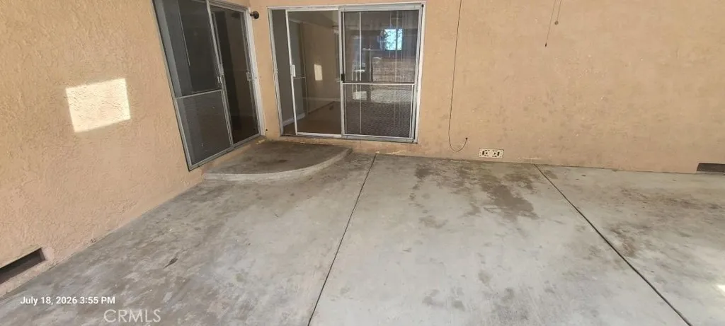 Rear covered patio with 2-sliding doors; Den & #3-bedrm.