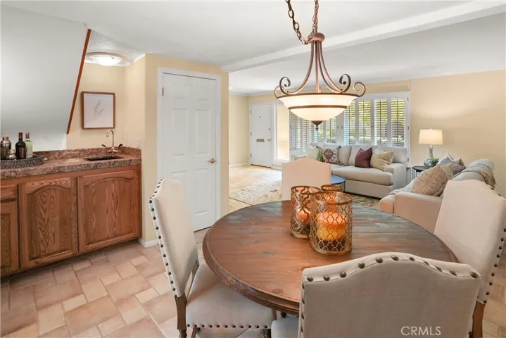 Dining area of living room with wet bar and small sink