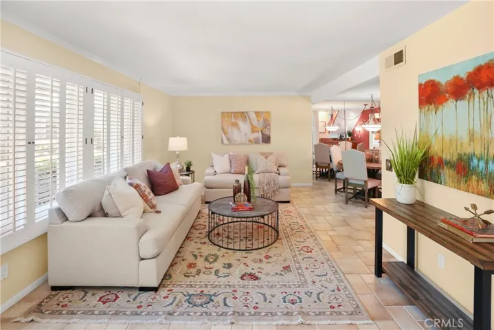 Living room with dual pane windows and custom shutters