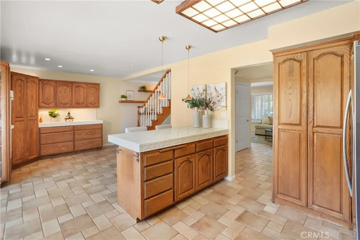 Kitchen opens to family with many custom made cabinets