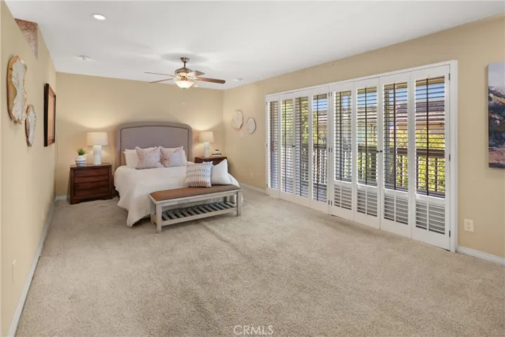 Master bedroom with balcony and custom shutters