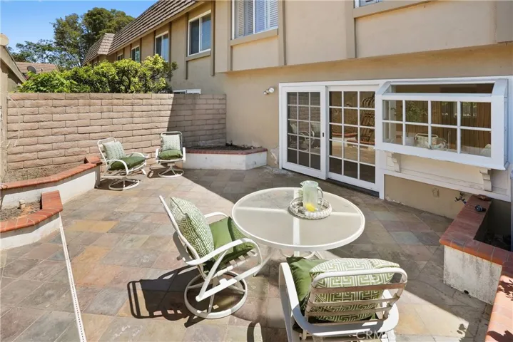 Patio area with custom build in planters, block wall and tile flooring