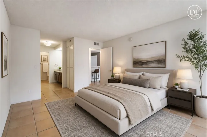 Primary bedroom with bathroom, double sinks and shower over tub
