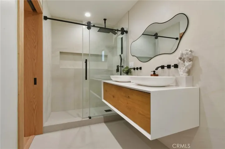 Sleek master bathroom, featuring luxury, smart toilet with integrated lighting and advanced features, complete with modern tiling, a crisp white vanity, and premium finishes