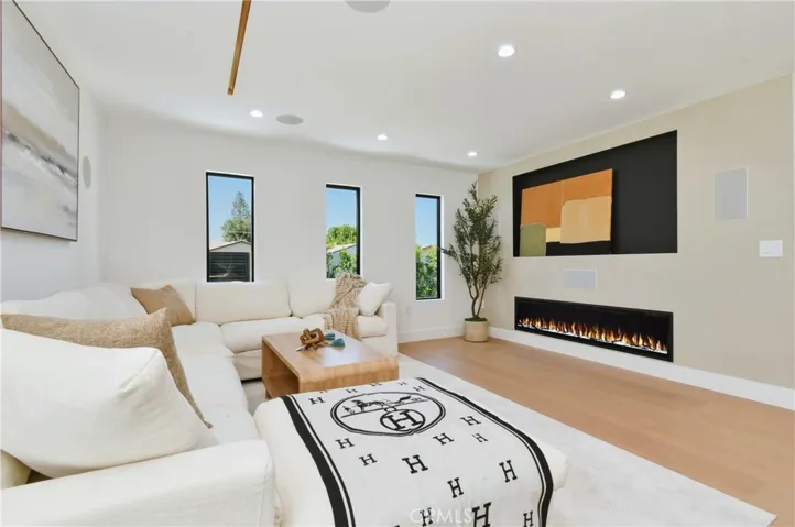 Cozy family room featuring a stylish accent wall with custom built-ins and an integrated fireplace
