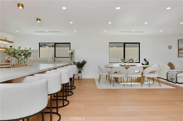 Seamless transition from the entryway into the main living spaces, highlighted by recessed lighting and neutral tones.