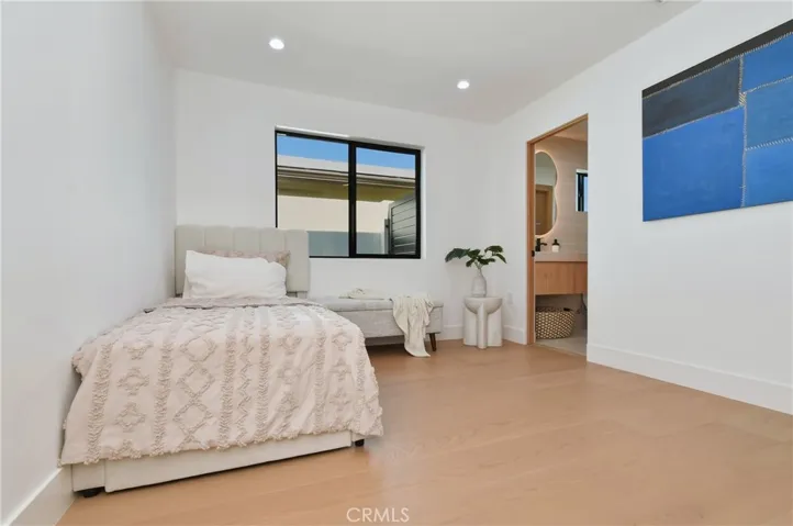 View of the secondary bedroom showcasing closet space and clean architectural lines