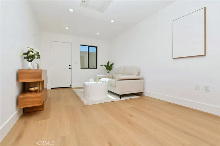 Bright and inviting ADU living area showcasing beautiful light wood flooring and an open-concept layout