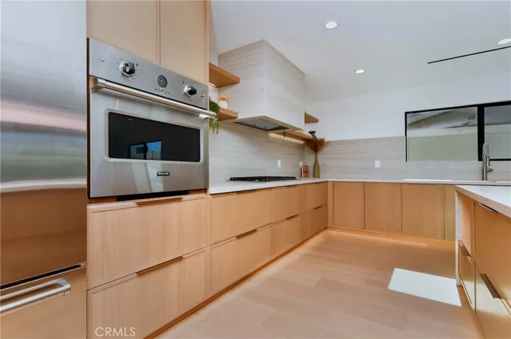 Close-up perspective of the premium wood-grain cabinetry accents and brand new high-end integrated appliance suite - SUB ZERO & VIKING