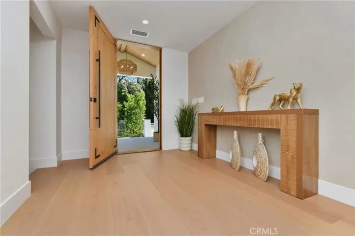 Light-filled entryway flow opening directly into a beautifully scaled, minimalist great room layout