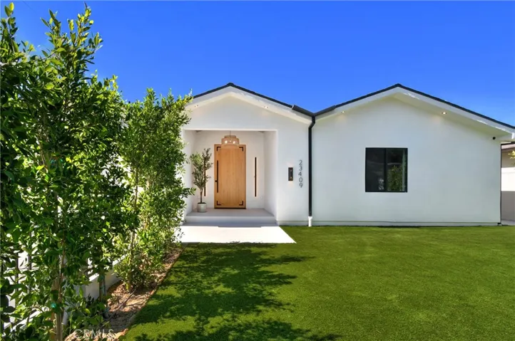 Alternative front exterior view showcasing the manicured landscaping