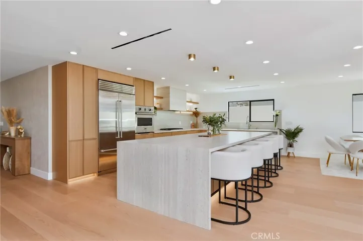 Alternative angle of the designer kitchen highlighting the vast countertops and minimalist architectural lighting.