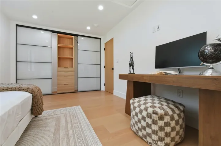 Closet with integrated LED-lit shelving, custom built-in organizers with, drawers, and extensive hanging space