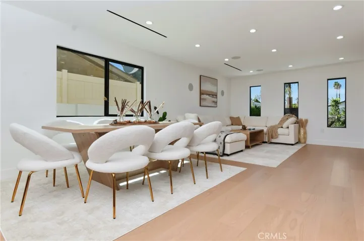 Comfortable secondary seating area or breakfast nook right off the kitchen, featuring wide windows and natural light