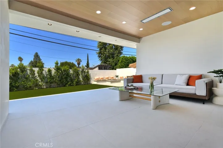 Stunning covered patio area seamlessly blending indoor-outdoor living, perfect for entertaining