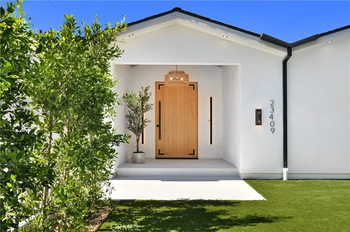 Elegant contemporary front door entry welcoming you into a bright and open floor plan