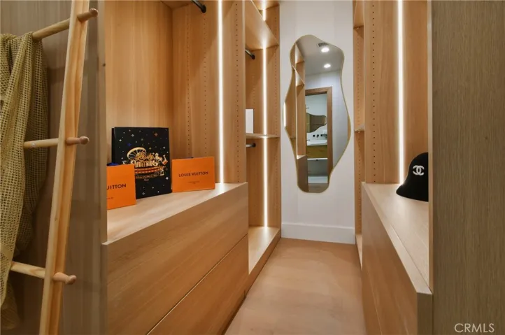 Sleek hallway transition featuring rich wood cabinetry and clean, modern architectural lines.