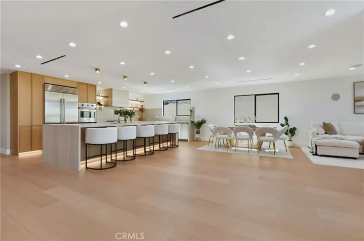 Spectacular open-concept core seamlessly blending dining, lounge, and a premium kitchen equipped with brand new Sub-Zero and Viking appliances.
